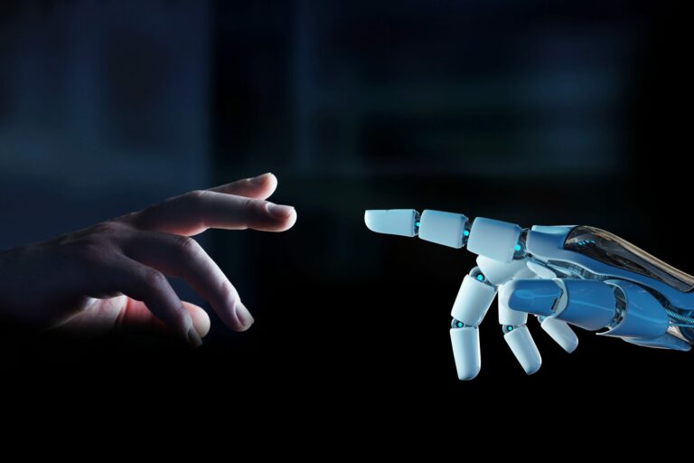 Human hand and robotic hand point at each other