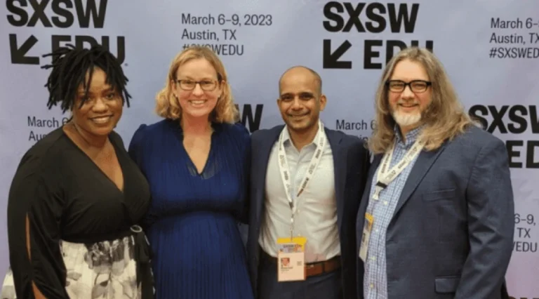 Four smiling people in front of an SXSW backdrop.