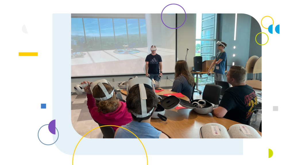 A student in front a classroom wearing a VR headset.