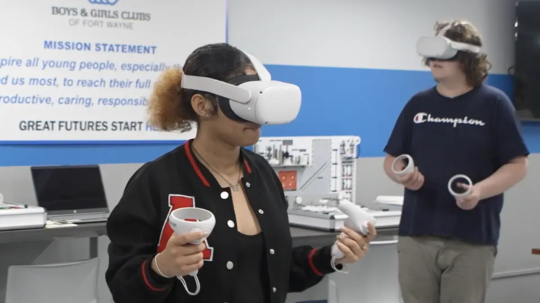A person using a VR headset in the foreground and another using a headset in the background.